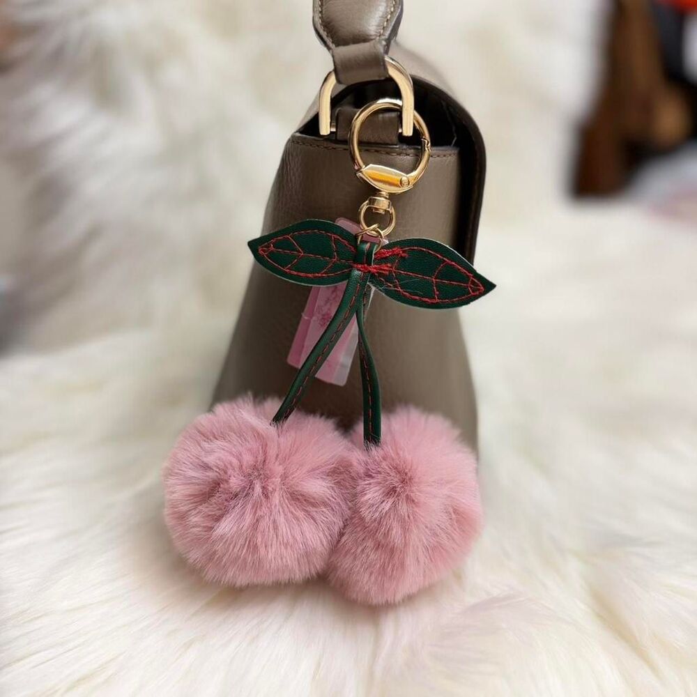 Pink fur pom pom keychain with green bow